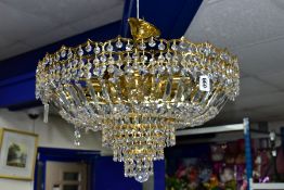 A MODERN BRASS AND GLASS ELECTROLIER, the ceiling hanging light fitted for six bulbs above tiers