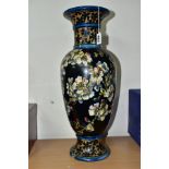 A DOULTON LAMBETH FAIENCE BALUSTER VASE DECORATED BY MARY BUTTERTON, the dark blue ground painted