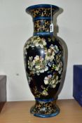 A DOULTON LAMBETH FAIENCE BALUSTER VASE DECORATED BY MARY BUTTERTON, the dark blue ground painted