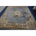 A CHINESE WOOLLEN BLUE AND CREAM GROUND CARPET SQUARE 306cm x 206cm (sd and in need of cleaning)