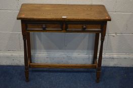 A REPRODUCTION OAK SIDE TABLE with two drawers width 76cm x depth 31cm x height 69cm