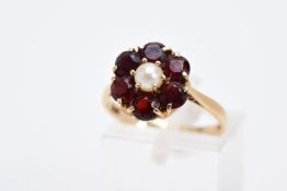 A 9CT GOLD GARNET AND PEARL CLUSTER RING, designed with a central single cultured pearl, within a