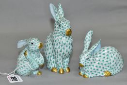 THREE HEREND RABBITS, all with green and white decoration, all modelled in different poses,