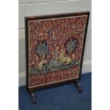 A MAHOGANY FIRESCREEN displaying a needlework medieval scene 56.5cm x height 79cm