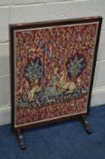A MAHOGANY FIRESCREEN displaying a needlework medieval scene 56.5cm x height 79cm