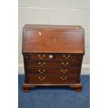 A REPRODUCTION GEORGE III MAHOGANY AND CROSSBANDED MINIATURE BUREAU fitted interior above five