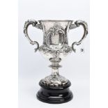 A SILVER TROPHY CUP WITH STAND, the double handled trophy cup of a foliate and scroll detailed