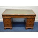 A REPRODUCTION WALNUT PEDESTAL DESK with nine various drawers width 136cm x depth 70cm x height 75cm