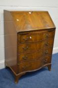 A REPRODUCTION MAHOGANY SERPENTINE BUREAU with a fitted interior above four drawers on bracket