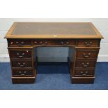 A MAHOGANY BROWN LEATHER AND GILT TOOLED INLAY TOP three frieze drawers above two banks three