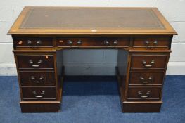 A MAHOGANY BROWN LEATHER AND GILT TOOLED INLAY TOP three frieze drawers above two banks three