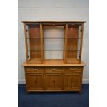 AN ERCOL ARLINGTON BLONDE ELM DISPLAY CABINET the top section with twin glazed cabinets and two