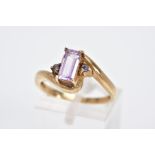 A 9CT GOLD AMETHYST RING, of cross over design, set with a central rectangular cut amethyst