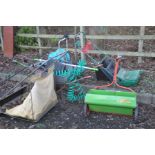 A COLLECTION OF GARDEN TOOLS including a wheel barrow lawn raker lawn seeder a Qualcast lawn