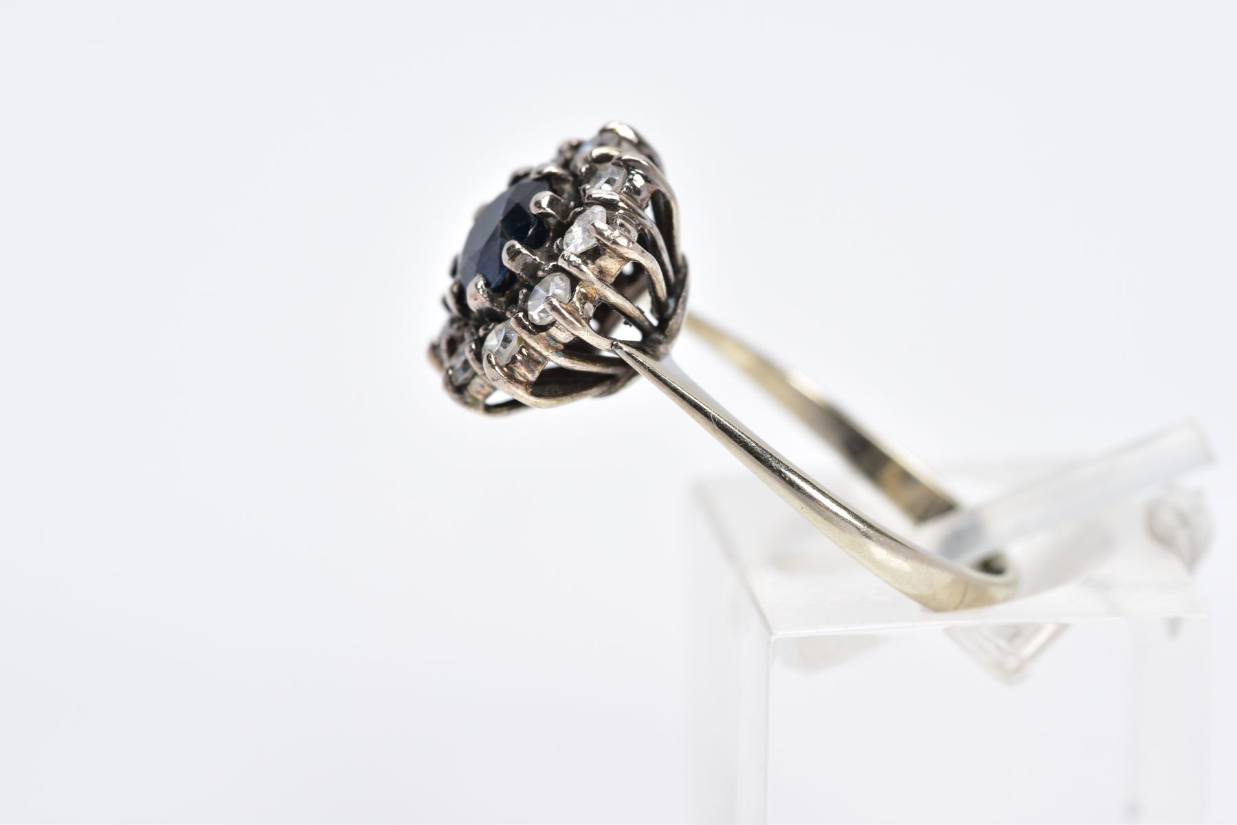 A WHITE METAL SAPPHIRE AND DIAMOND CLUSTER RING, designed with a central circular cut blue - Image 2 of 3