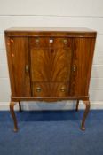 A REPRODUCTION MAHOGANY DRINKS CABINET rounded front corner cupboard doors flanking two drawers