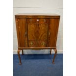 A REPRODUCTION MAHOGANY DRINKS CABINET rounded front corner cupboard doors flanking two drawers