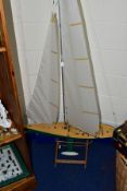 A REMOTE CONTROL POND YACHT OF PLASTIC CONTRUCTION WITH ALUMINIUM MAST, height including mast and