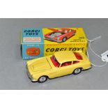 A BOXED CORGI TOYS ASTON MARTIN D.B.4, No 218, primrose yellow body, with bonnet vent, red interior,