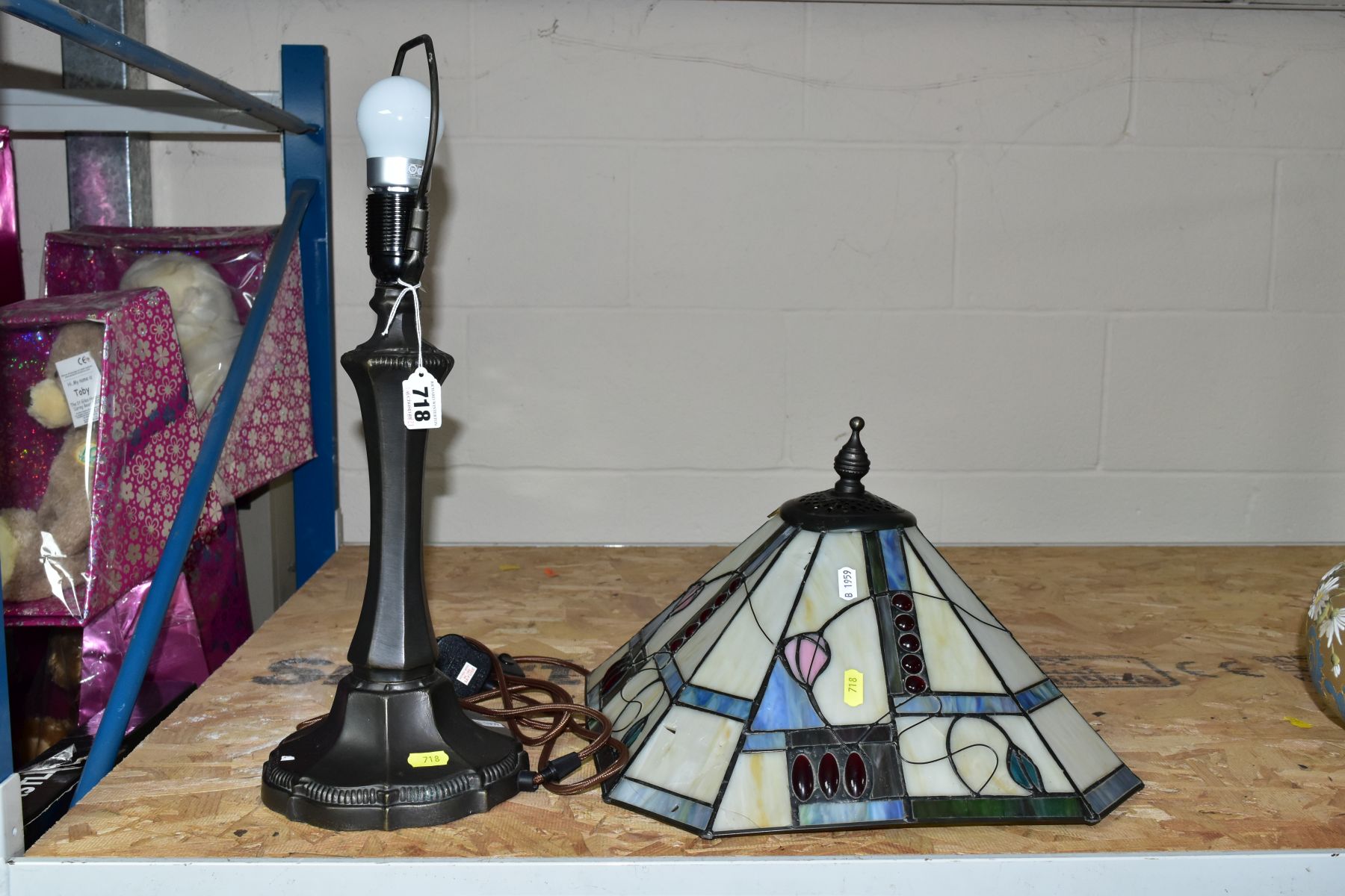 A MODERN TABLE LAMP WITH COLOURED GLASS LEADED SHADE, on a bronzed base, both shade and base have