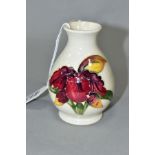 A MOORCROFT POTTERY SQUAT BALUSTER VASE, Orchid decoration on a cream ground, impressed marks,