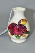 A MOORCROFT POTTERY SQUAT BALUSTER VASE, Orchid decoration on a cream ground, impressed marks,