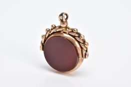 A 9CT GOLD SWIVEL FOB, of circular design swivels to reveal bloodstone and carnelian panels, to a