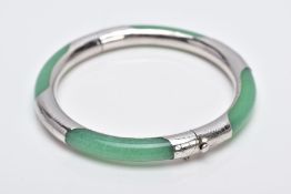 A WHITE METAL AND JADE HINGED BANGLE, jade bangle lined with a decorative white metal lining, fitted