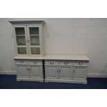 A TWO PIECE CREAM FINISH DINING SUITE, comprising a glazed two door dresser with two glass
