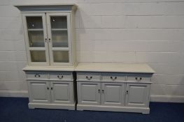 A TWO PIECE CREAM FINISH DINING SUITE, comprising a glazed two door dresser with two glass