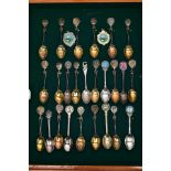 A CASED COLLECTION OF SILVER AND SILVER PLATED GOLFING TEA SPOONS, housed in a wooden glass
