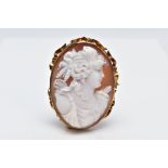 A YELLOW METAL CAMEO BROOCH, of an oval form depicting a lady in profile within a collet mount