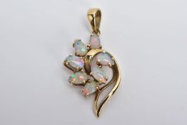 A YELLOW METAL OPAL PENDANT, designed with spray of pear cut opal cabochons on a yellow metal