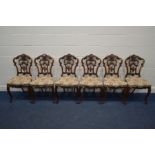 A SET OF SIX VICTORIAN WALNUT CHAIRS, with elaborate foliate carved backs, on cabriole front legs,