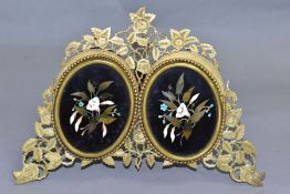 A VICTORIAN GILT METAL AND PIETRA DURA MOUNTED PHOTOGRAPH FRAME, the oval floral panels set within