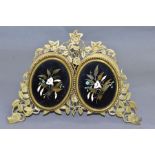 A VICTORIAN GILT METAL AND PIETRA DURA MOUNTED PHOTOGRAPH FRAME, the oval floral panels set within