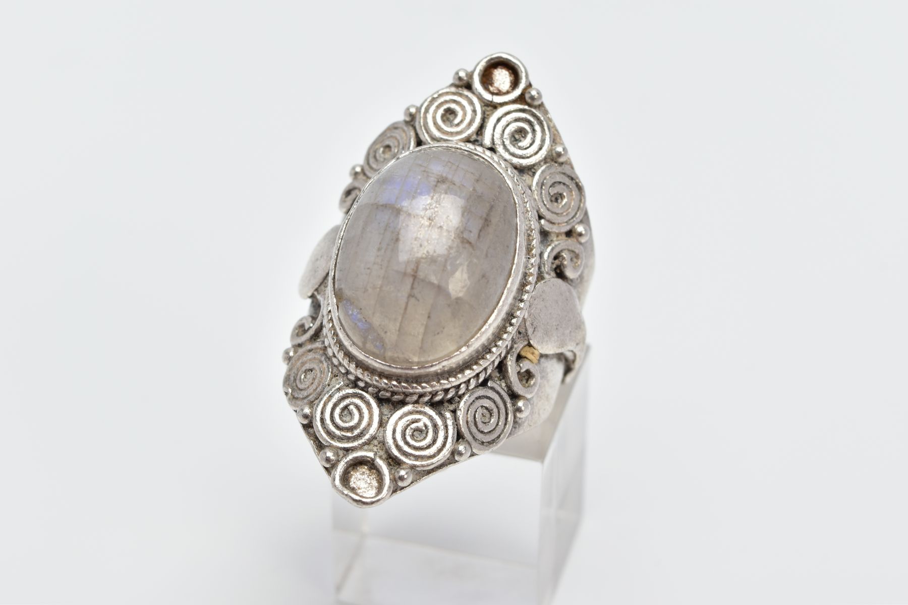 A LARGE LABRADORITE CABOCHON RING, designed with a central oval labradorite cabochon within a beaded