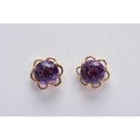 A PAIR OF 9CT GOLD AMETHYST EARRINGS, each designed with a central circular cut amethyst within an