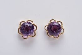 A PAIR OF 9CT GOLD AMETHYST EARRINGS, each designed with a central circular cut amethyst within an