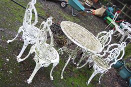 A WHITE CAST ALUMINIUM GARDEN TABLE 80cm in diameter and four similar chairs