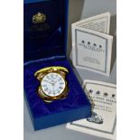 A HALCYON DAYS ENAMELLED QUARTZ TRAVELLING ALARM CLOCK, together with box, diameter approximately