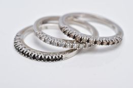 THREE WHITE METAL DIAMOND STACKING RINGS, each designed as a half hoop ring, the first set with a