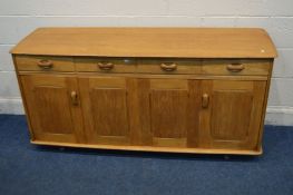 A BLONDE OAK PRIORY SIDEBOARD with four drawers above two bi-fold cupboard doors enclosing a