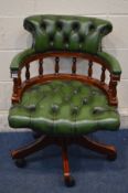 A REPRODUCTION MAHOGANY BUTTONED GREEN LEATHER SWIVEL OFFICE ARMCHAIR