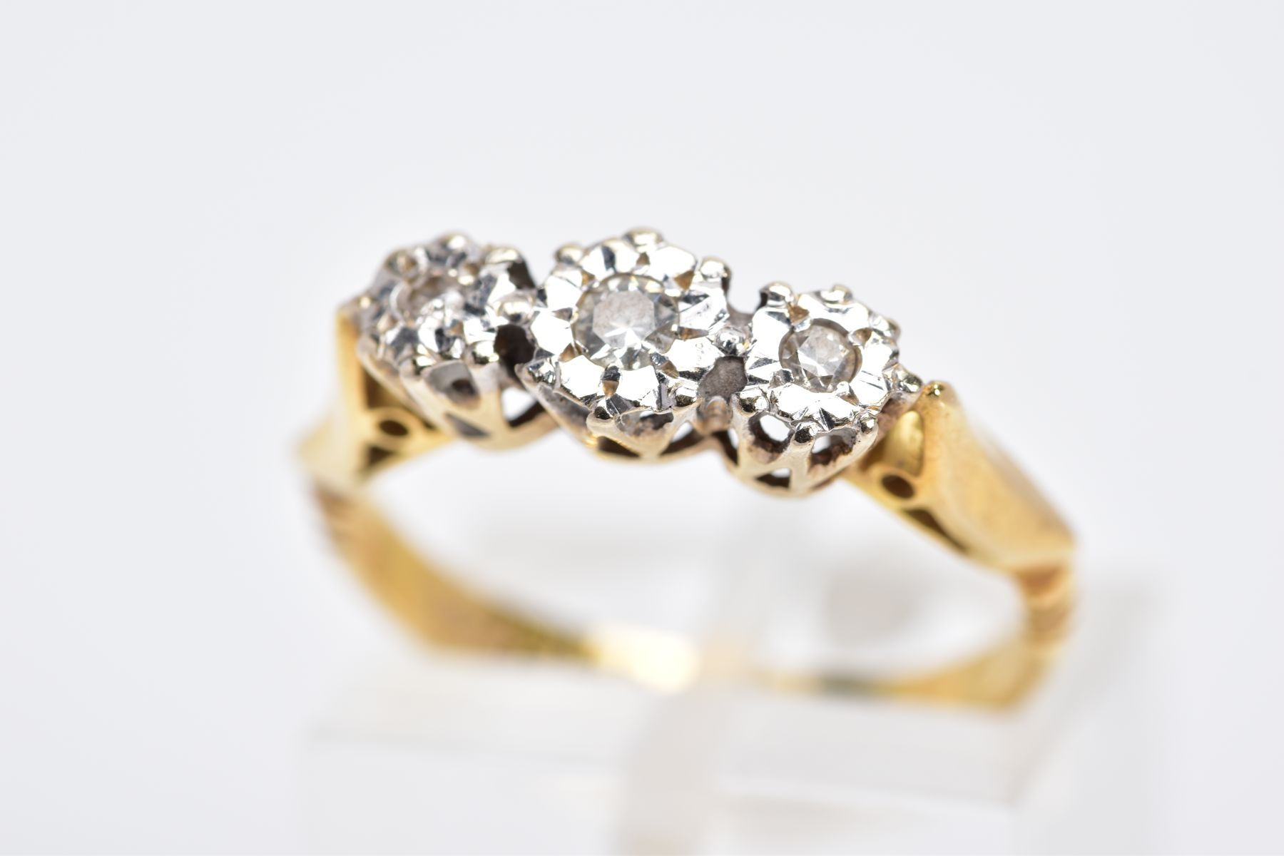 A MID 20TH CENTURY THREE STONE DIAMOND RING, three round brilliant cut diamonds illusion set,