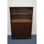 A MODERN MAHOGANY GLAZED SLIDING DOOR BOOKCASE, with two drawers above double cupboard doors,