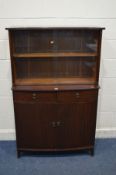 A MODERN MAHOGANY GLAZED SLIDING DOOR BOOKCASE, with two drawers above double cupboard doors,