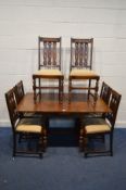 AN EARLY TO MID 20TH CENTURY OAK DRAW LEAF TABLE, on turned legs united by a H stretcher, extended