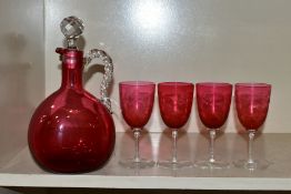 A 19TH CENTURY CRANBERRY GLASS DECANTER, together with four cranberry glass bowl wine glasses,