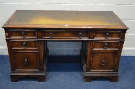 A REPRODUCTION OAK PEDESTAL DESK, tan leather and gilt tooled inlay top, and seven various